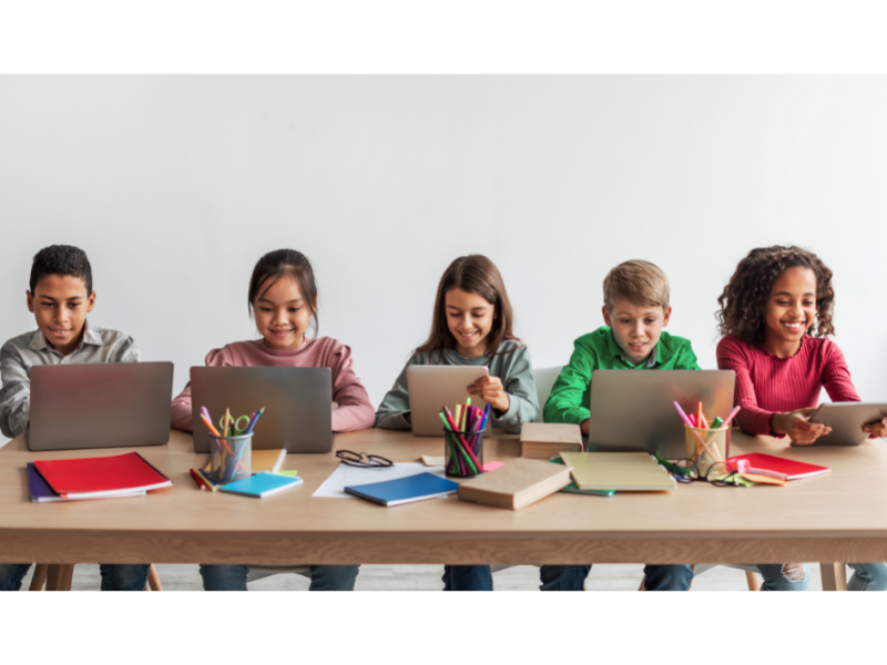 Students at Table with Laptops